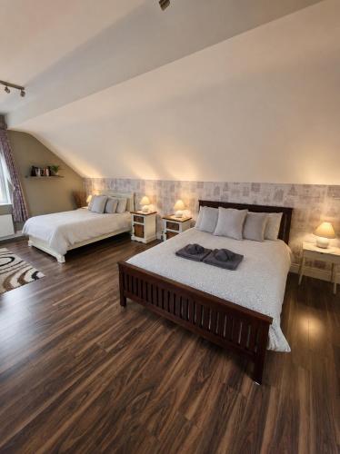 a large bedroom with two beds and two lamps at Tully View House in Donegal