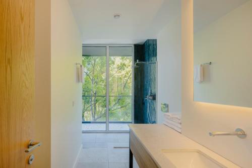 a bathroom with a sink and a large window at Buknari Hotel in Buknari