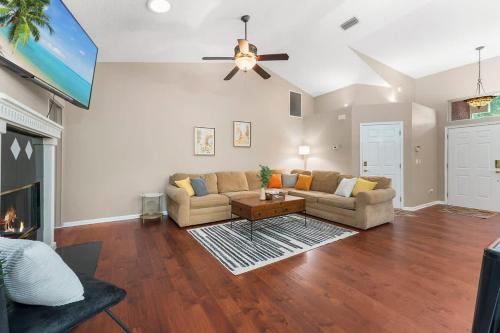 a living room with a couch and a ceiling fan at Costal Lane - Main in Jacksonville