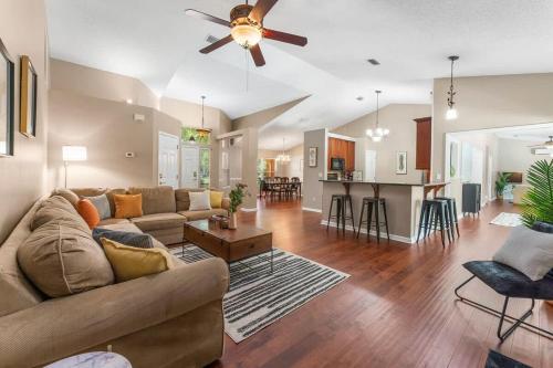 a living room with a couch and a ceiling fan at Costal Lane - Main in Jacksonville