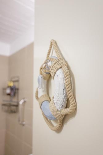 a rope hanging on a wall in a bathroom at Pasithea Sunset in Milopótamos