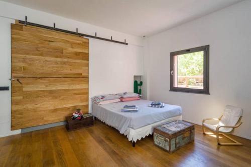 a bedroom with a bed and a large wooden wall at Villa Giuanne in Arenzano