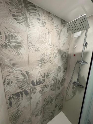 a shower stall with a glass door with plants on it at Casa Gina in Chioggia
