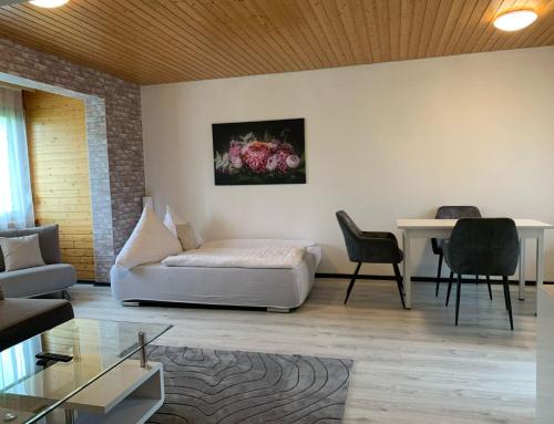 a living room with a couch and a table at Appartment im Schwarzwald in Furtwangen