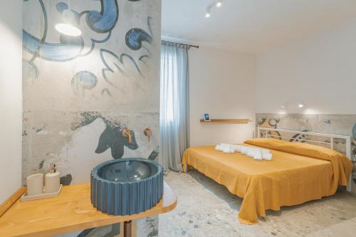 a bedroom with a bed and a tub in it at Casa Ritunno Rooms in Favignana