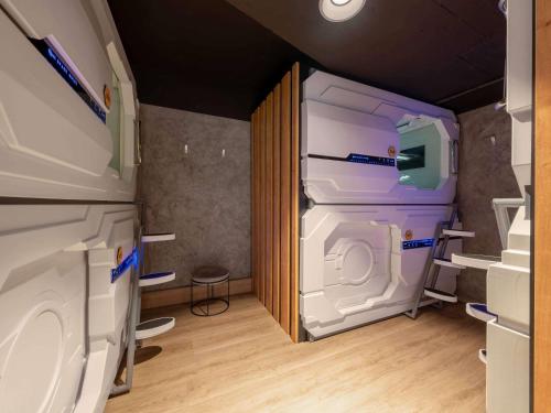 a bathroom with a washing machine in a room at ibis Styles Ljubljana The Fuzzy Log in Ljubljana