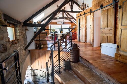 an attic hallway with wooden floors and wooden beams at Une demeure d'exception au cœur des Alpes du Sud in Venterol