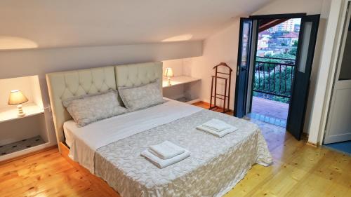 a bedroom with a bed with two towels on it at Dua 1 Apartments Shkoder in Shkodër