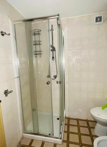 a glass shower in a bathroom with a toilet at Lido del Sole bilo 28 in Rodi Garganico