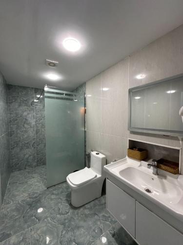 a bathroom with a toilet and a sink and a shower at Relax Beach Astara in Astara