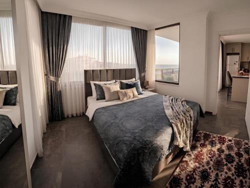 a bedroom with a large bed with a large window at Beyaz Kosk in Demre