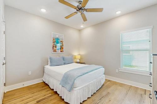 a bedroom with a bed and a ceiling fan at Gone Coastal Cottage in Rockport
