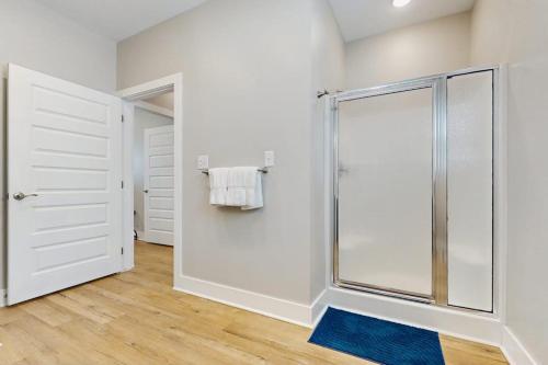 a bathroom with a shower with a glass door at Gone Coastal Cottage in Rockport