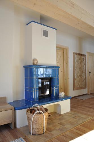 a living room with a blue fireplace in a room at Vera Jasná in Belá