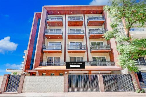 an apartment building with a sign in front of it at Super Townhouse Oak Sector 39 Medanta in Gurgaon