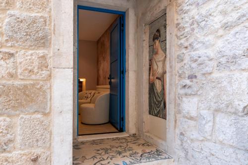 a doorway into a room with a couch and a mirror at Agava Design Residence in Split