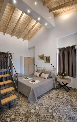 a bedroom with a large bed and a staircase at Villa Don Kostangelo in Nikiana