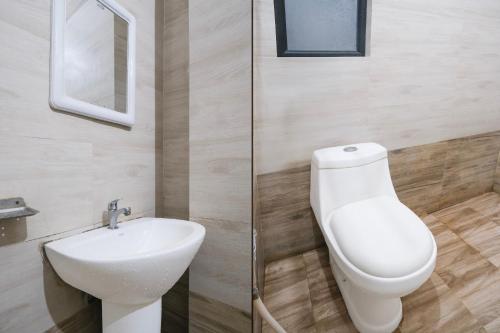 a bathroom with a toilet and a sink at Super Collection O Bashista Chariali Formerly Luit Heritage in Dispur