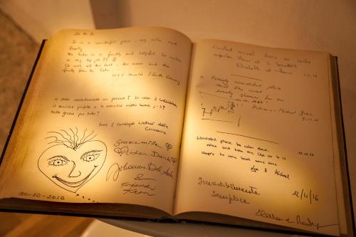 an open book with handwriting on the pages at La Casa del Poeta Enna - Pergusa in Enna
