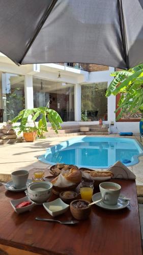 a table with bowls of food on a table with a pool at El Viejo Molino in Chilecito