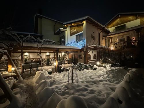 a yard covered in snow at night at NIKI HOUSE in Bansko