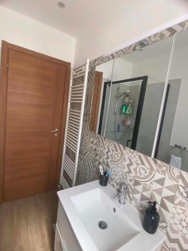 a bathroom with a sink and a mirror at Lo chalet sul lago in Ispra