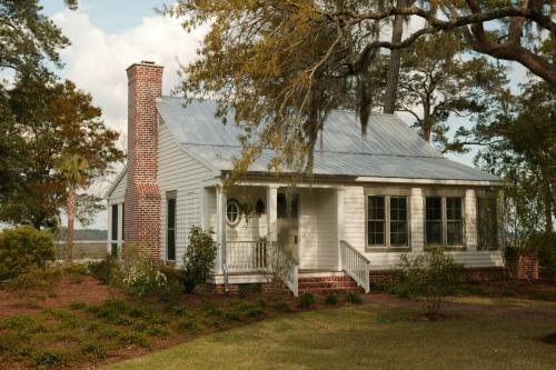 a white house with a brick chimney at Montage Palmetto Bluff in Bluffton