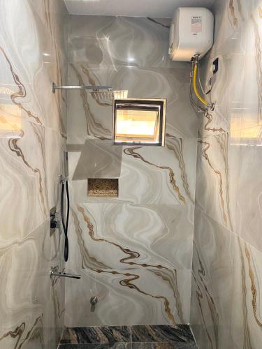 a bathroom with a shower with a window in it at Sennet Luxury Hotel in Uyo