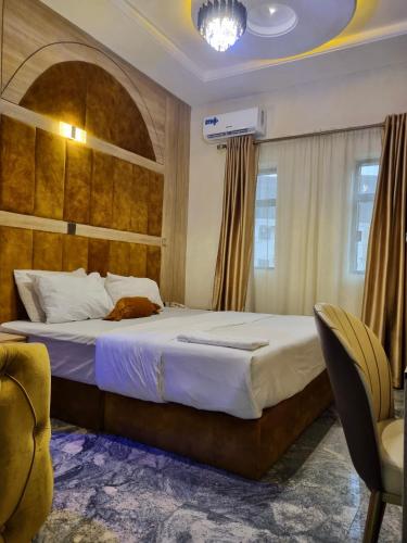 a bedroom with a large bed in a room at Sennet Luxury Hotel in Uyo
