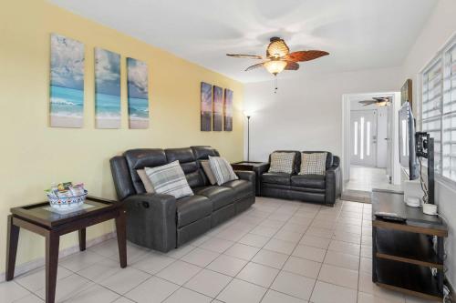 a living room with a couch and a table at Villa Jardin - Infinity Pool and Backyard Oasis in Luquillo