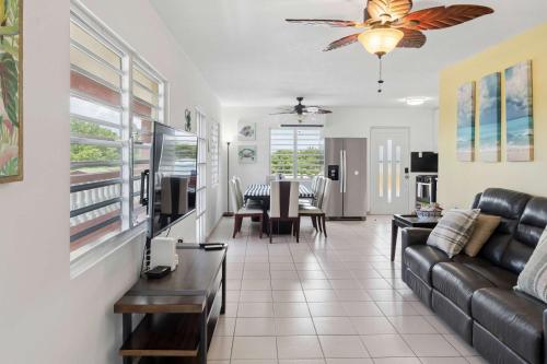 a living room with a couch and a table at Villa Jardin - Infinity Pool and Backyard Oasis in Luquillo