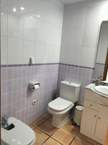 a bathroom with a toilet and a sink at Golf Paradise in Sant Jordi
