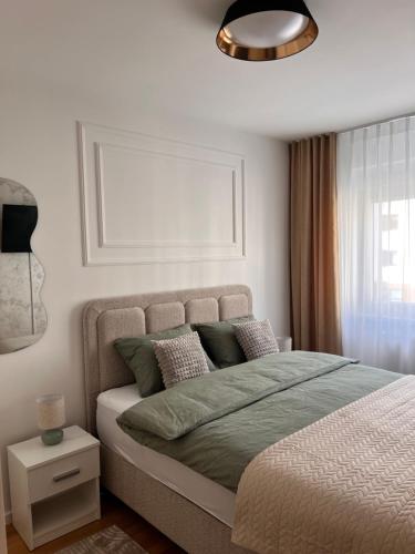 a bedroom with a large bed and a window at Apartman A&V in Vranješ