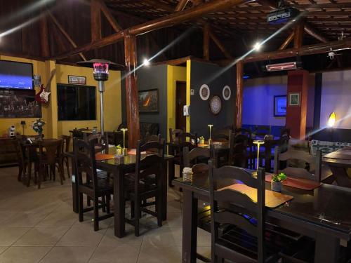 a restaurant with tables and chairs in a room at Estação Serramar in Lumiar
