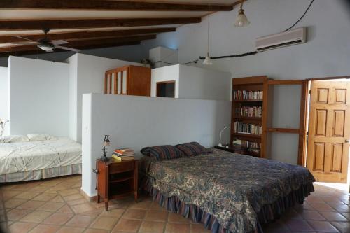 a bedroom with a bed and a book shelf at Large studio with private patio in Casa Cornucopia in San José del Cabo