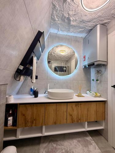 a bathroom with a sink and a mirror at A-Frame Villa - Kovačević Hills in Velika Kladuša