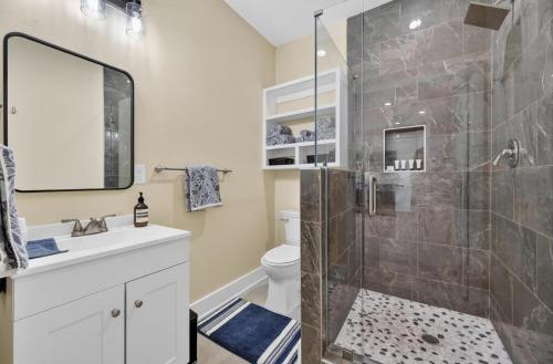 a bathroom with a shower with a toilet and a sink at Korovosoto Lodge in Dallas
