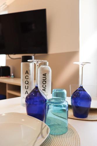 two blue glass bottles sitting on a table at Sanremo Apartments - A Due Passi in Sanremo