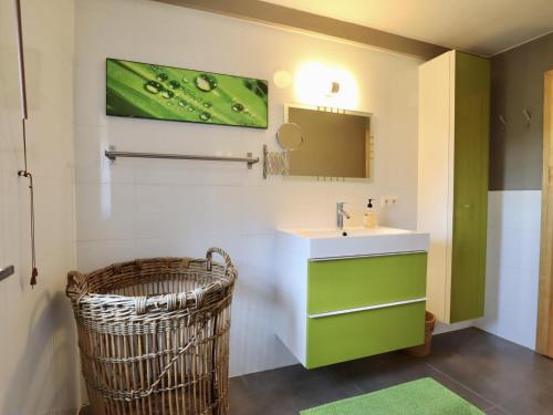 a bathroom with a sink and a mirror at Petit Wilogne in Houffalize