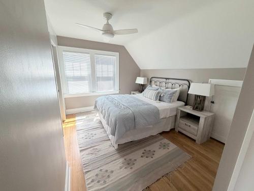 a bedroom with a bed and a ceiling fan at The Catalog Cottage in Minocqua
