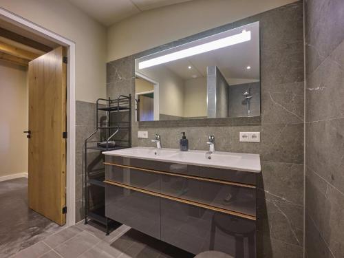 a bathroom with a sink and a mirror at Sientjeshof 1 in Diessen