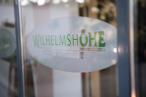 a white sign on a glass door with the words wildlife institute at Hotel Wilhelmshöhe Auderath in Auderath