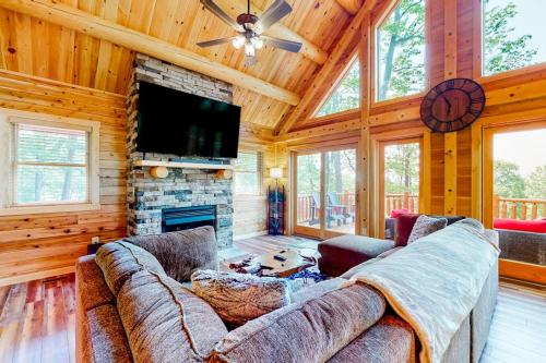 a living room with a couch and a fireplace at Deep Creek Mountain Retreat in McHenry