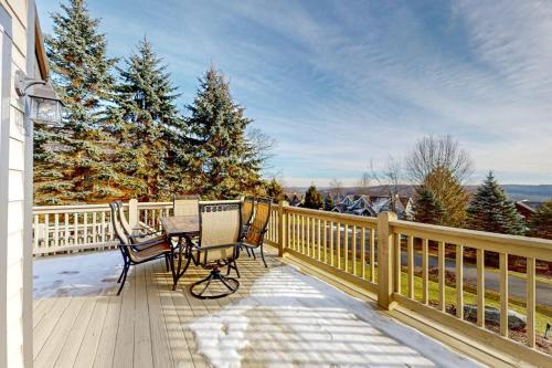 a wooden deck with a table and chairs on it at Bear's Eye View in McHenry