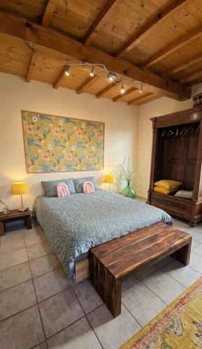 a bedroom with a large bed and a wooden table at Amore in Chianti in Greve in Chianti