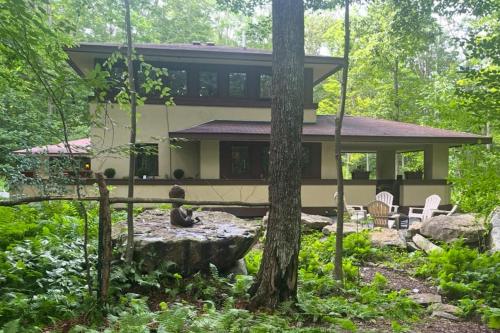 a house in the middle of a forest at The Frank Lloyd Wright Home @ Deep Creek, MD in Bittinger