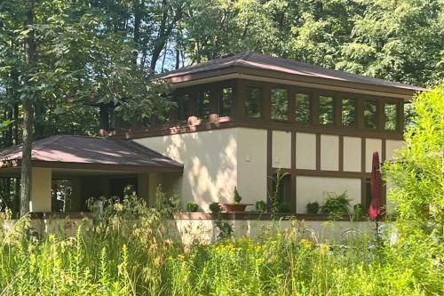 a large house with a lot of windows at The Frank Lloyd Wright Home @ Deep Creek, MD in Bittinger