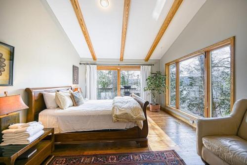 a bedroom with a bed and a couch and windows at A Million Dollar View in Oakland