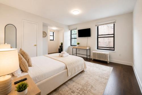 a bedroom with a large bed and a desk at Bay Ridge ApartHotel in Brooklyn