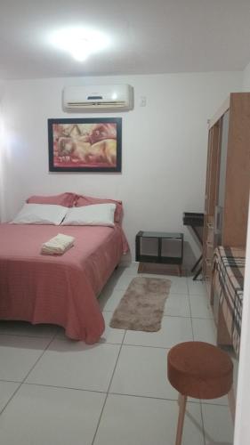 a bedroom with a bed with a red blanket at Condominio Reserva do Delta 1 in Parnaíba